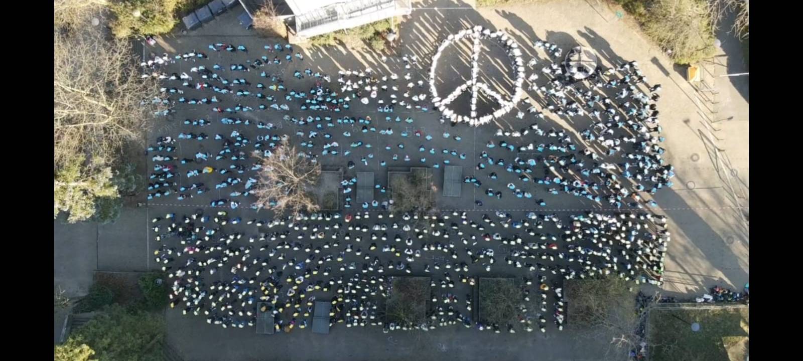 Friedensaktionen: Schüler bilden Peace-Zeichen